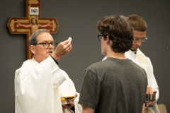 Father Ed Hopkins and Father Randall Meissen distribute Holy Communion