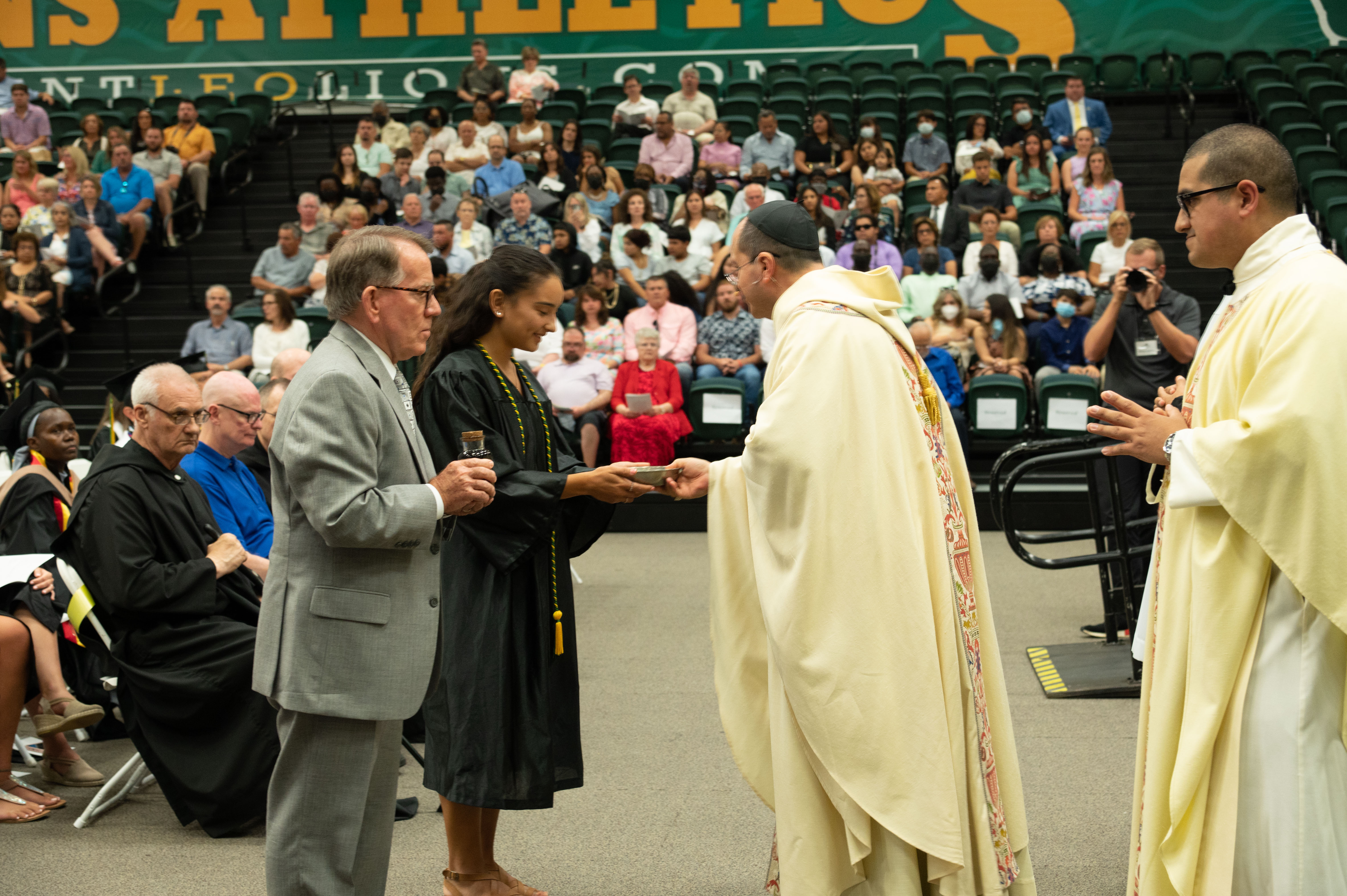 Graduate-Kennedy-Messina-and-Trustee-Chair-John-View-present-the-gifts-to-Abbot-Camacho-and-Father-Amarillas